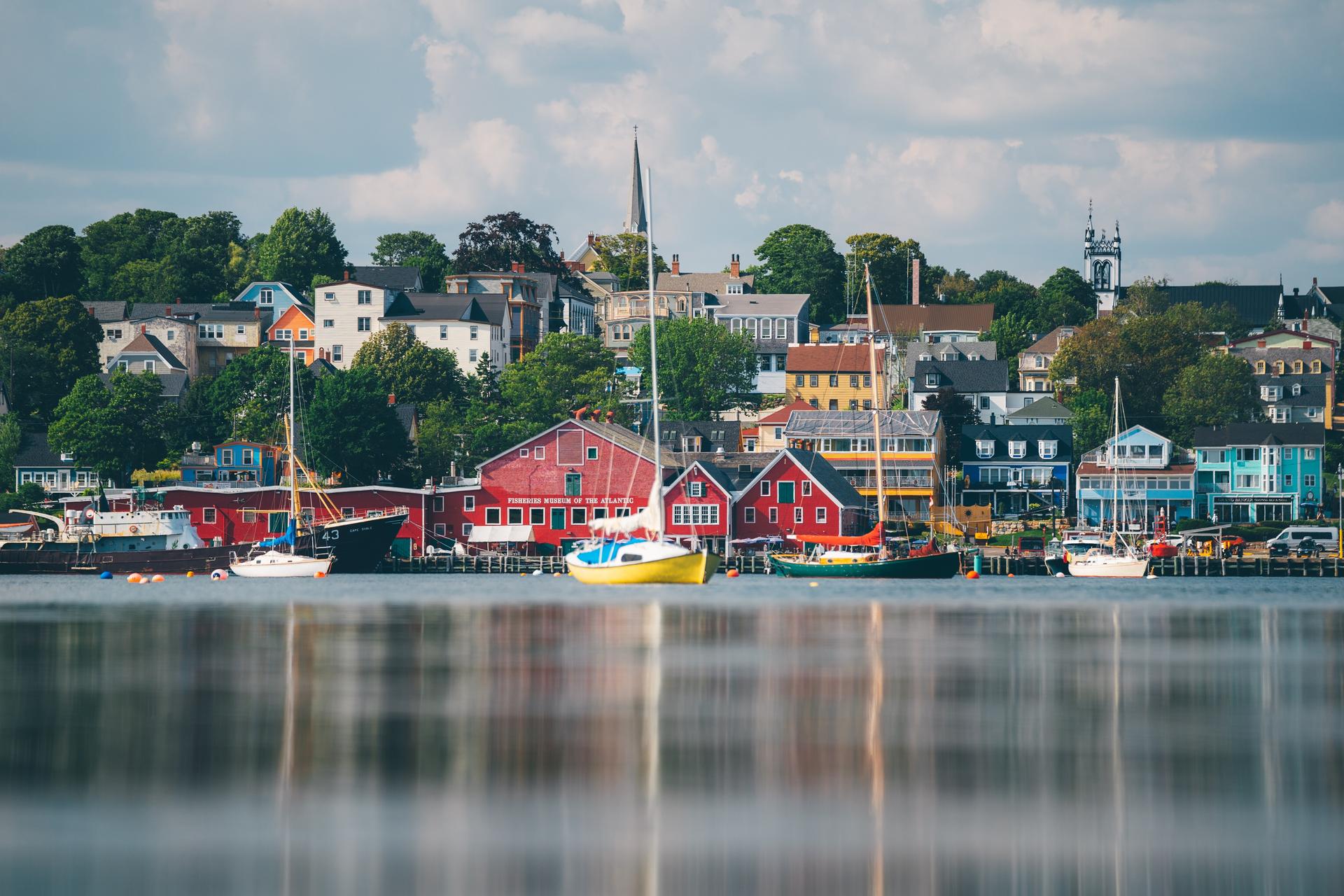 Colorful waterfront town with boats on calm water