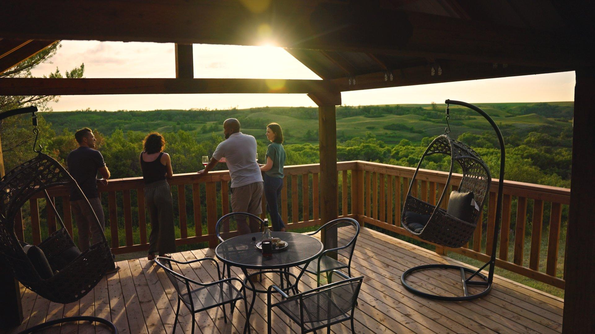 Patrons look over a vista while sampling wine