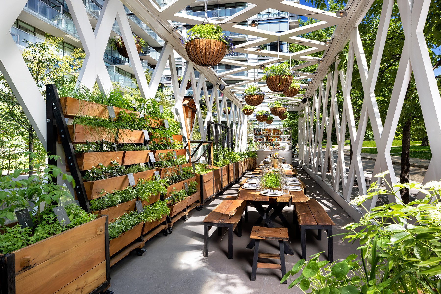 Outdoor tables in a garden space at 1 Hotel, Toronto