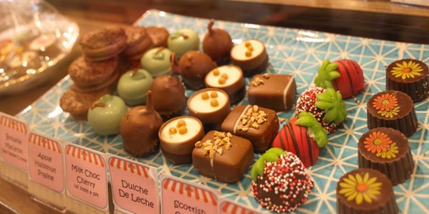 Fancy chocolate truffles in a display case.
