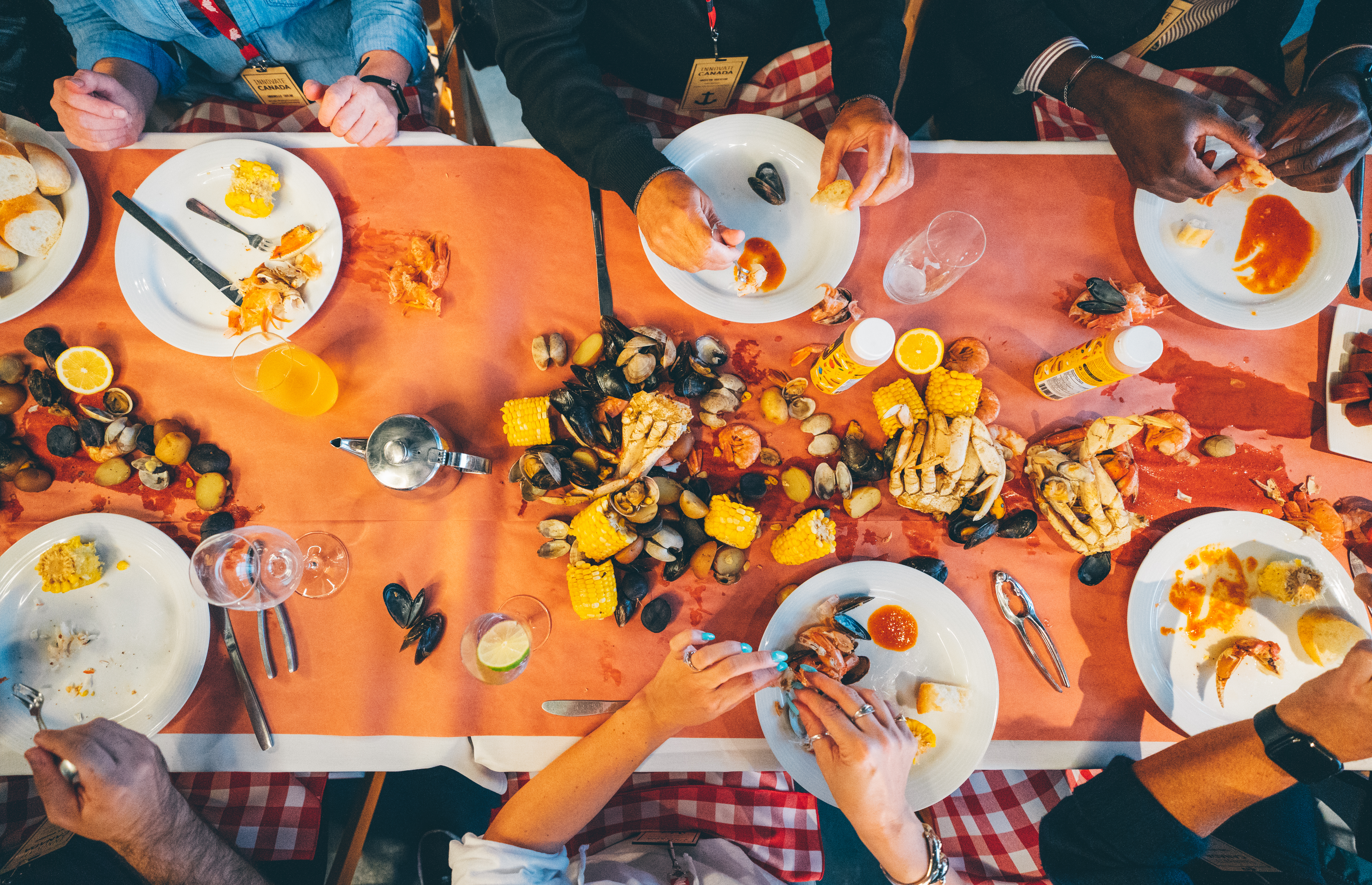 An overhead view of a table covered in seafood and corn on the cob.