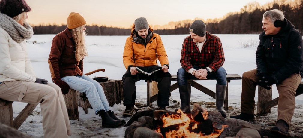 Group around a fire surrounded by snow