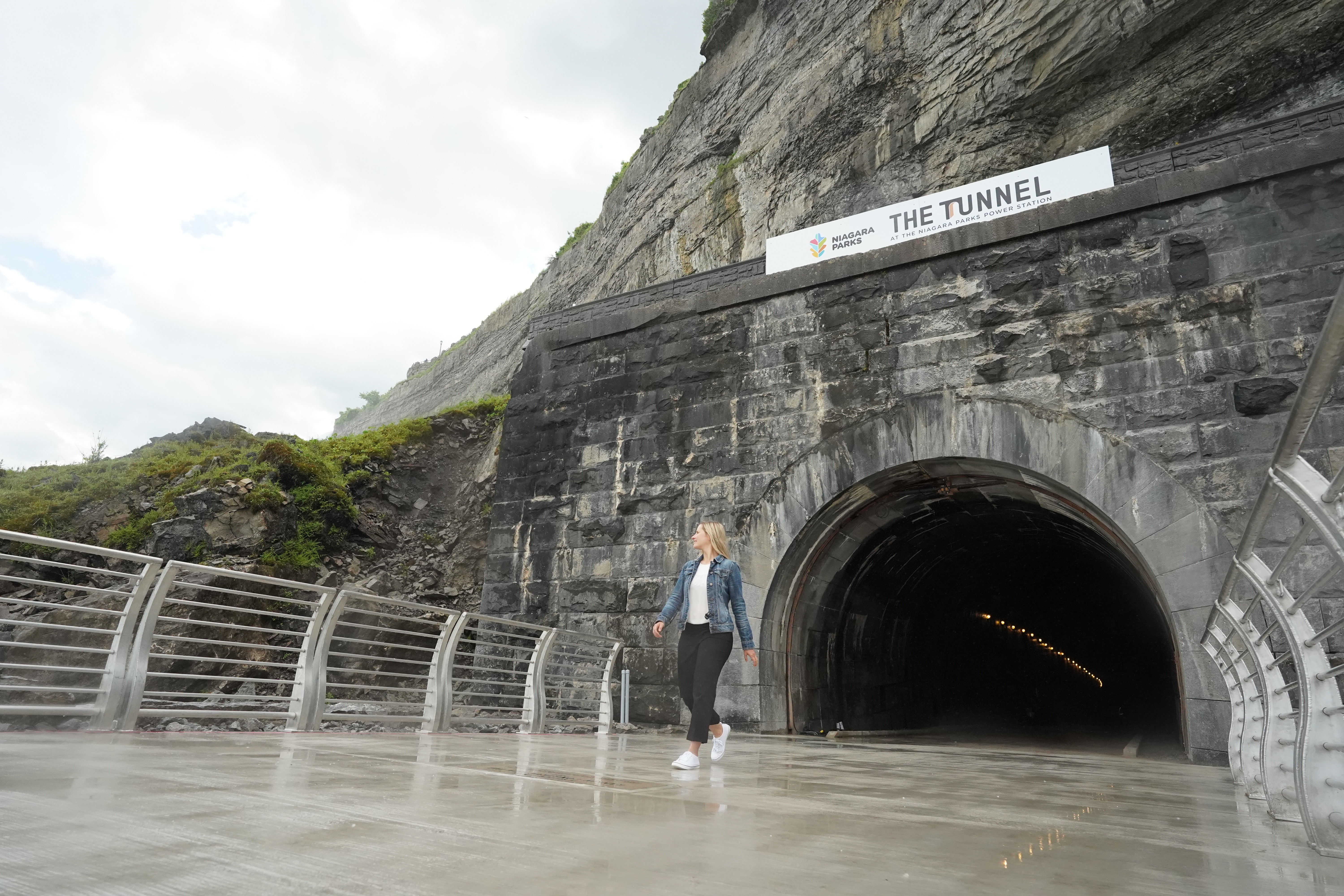 A woman walking out of the Niagara Parks Power Station tunnel.