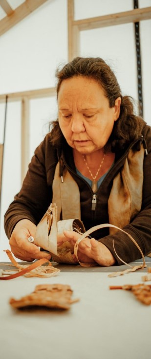 A person working with their hands at a table