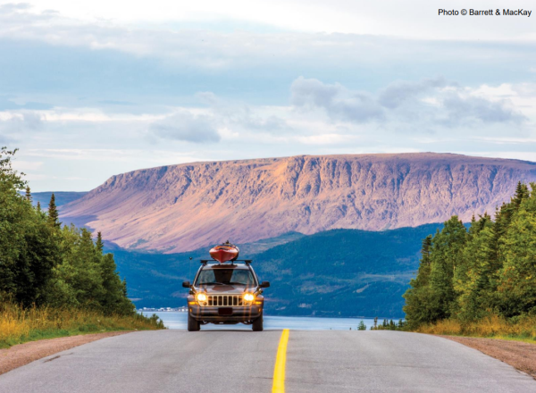 Car driving by mountainous Gros Morne Region